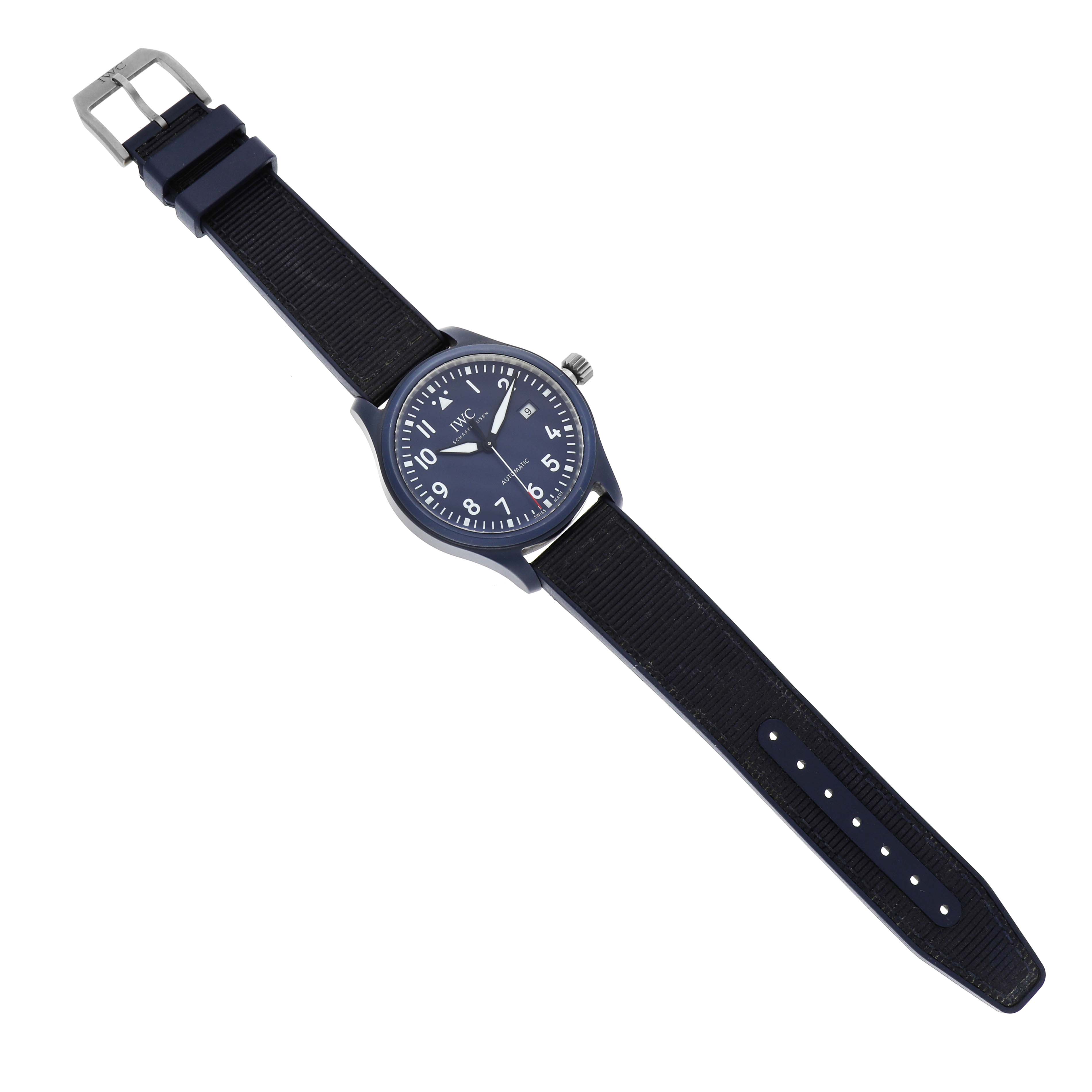 The IWC Pilot IW328101 Men's Ceramic Blue Dial model watch is shown from a top view, displaying its entire band, face, and buckle.