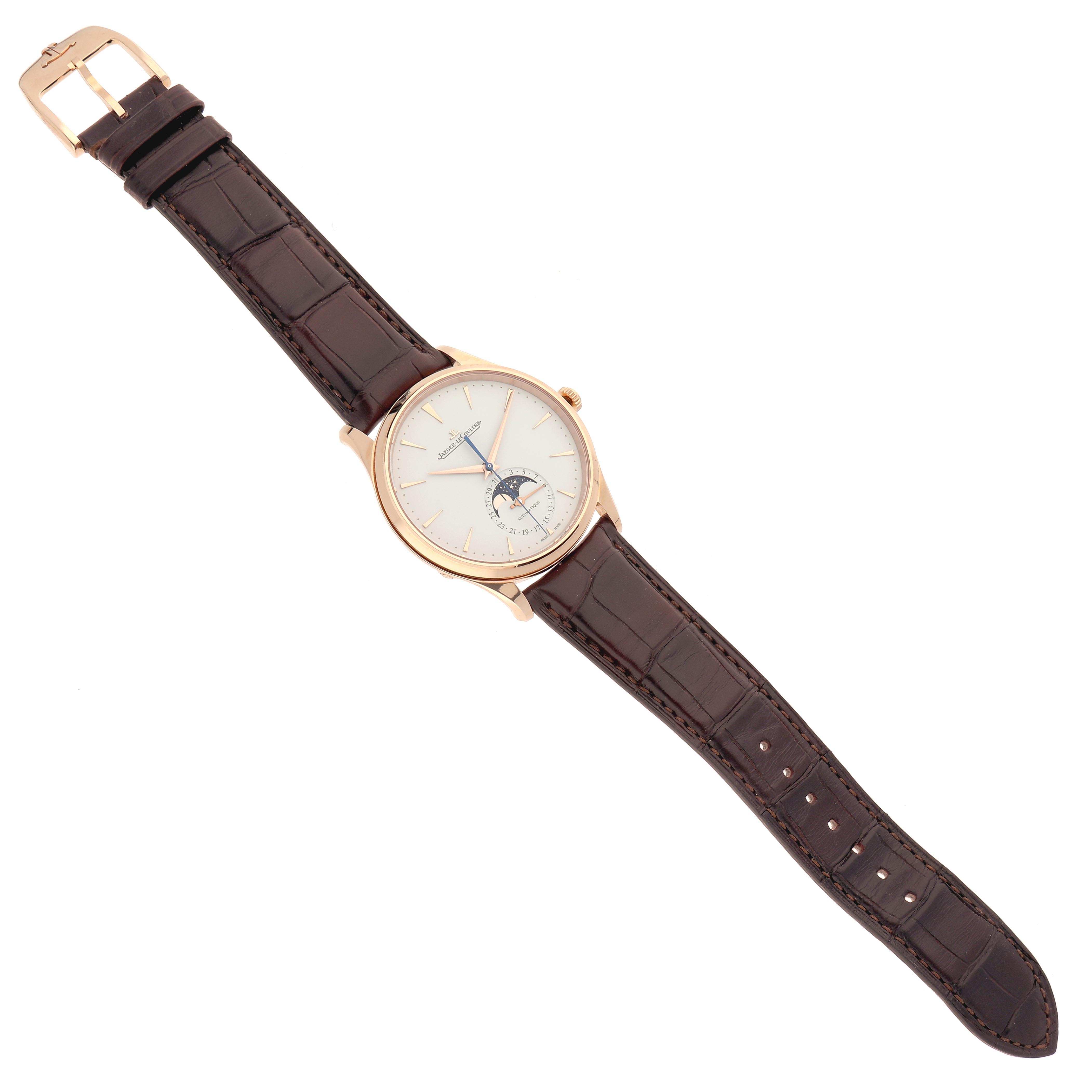 The Jaeger LeCoultre Master Q1362510 Men
s Rose Gold Beige Dial Q1362510 Men
s Rose Gold Beige Dial watch is shown from an overhead angle, displaying the face, case, strap, and buckle.