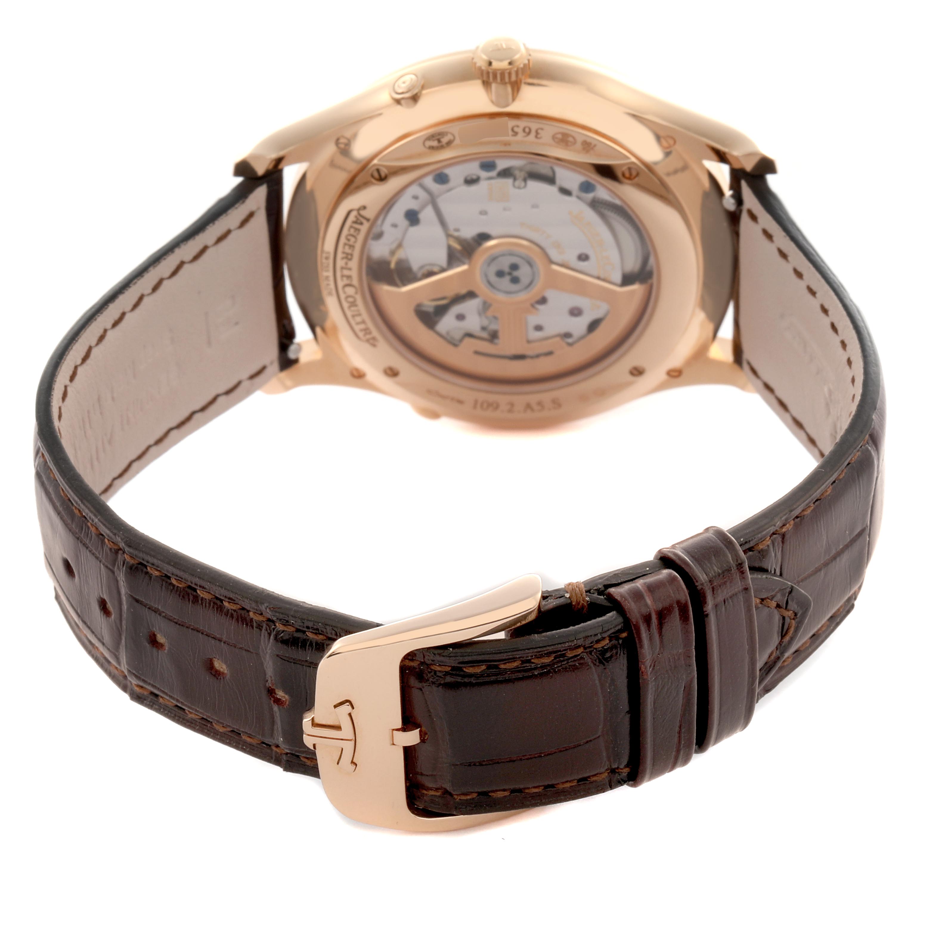 The image shows the Jaeger LeCoultre Master Q1362510 Men
s Rose Gold Beige Dial Q1362510 Men
s Rose Gold Beige Dial model from the back, highlighting the transparent case back and leather strap with buckle.