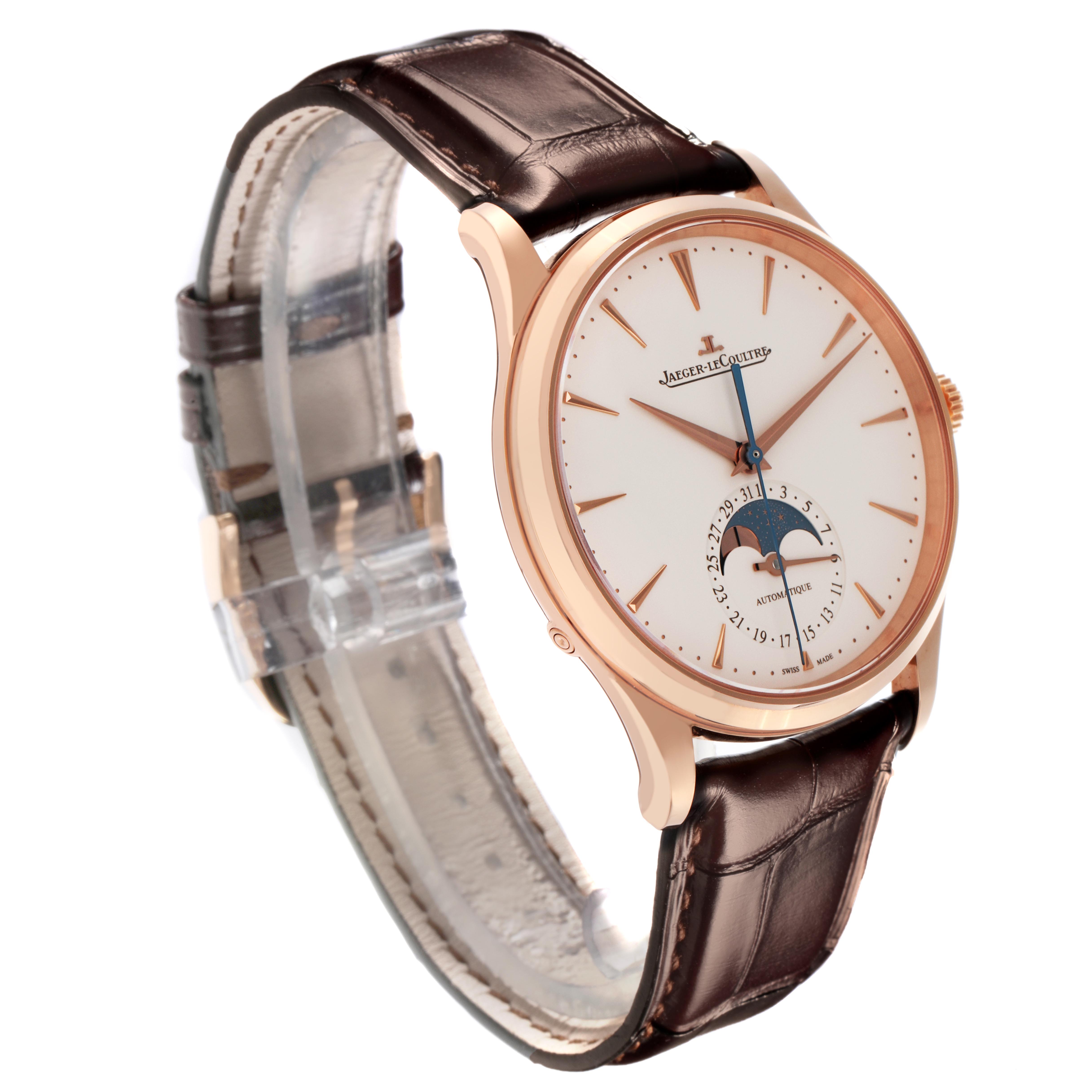 The Jaeger LeCoultre Master Q1362510 Men
s Rose Gold Beige Dial Q1362510 Men
s Rose Gold Beige Dial watch is shown at an angle displaying the face, rose gold case, brown leather strap, and moon phase complication.