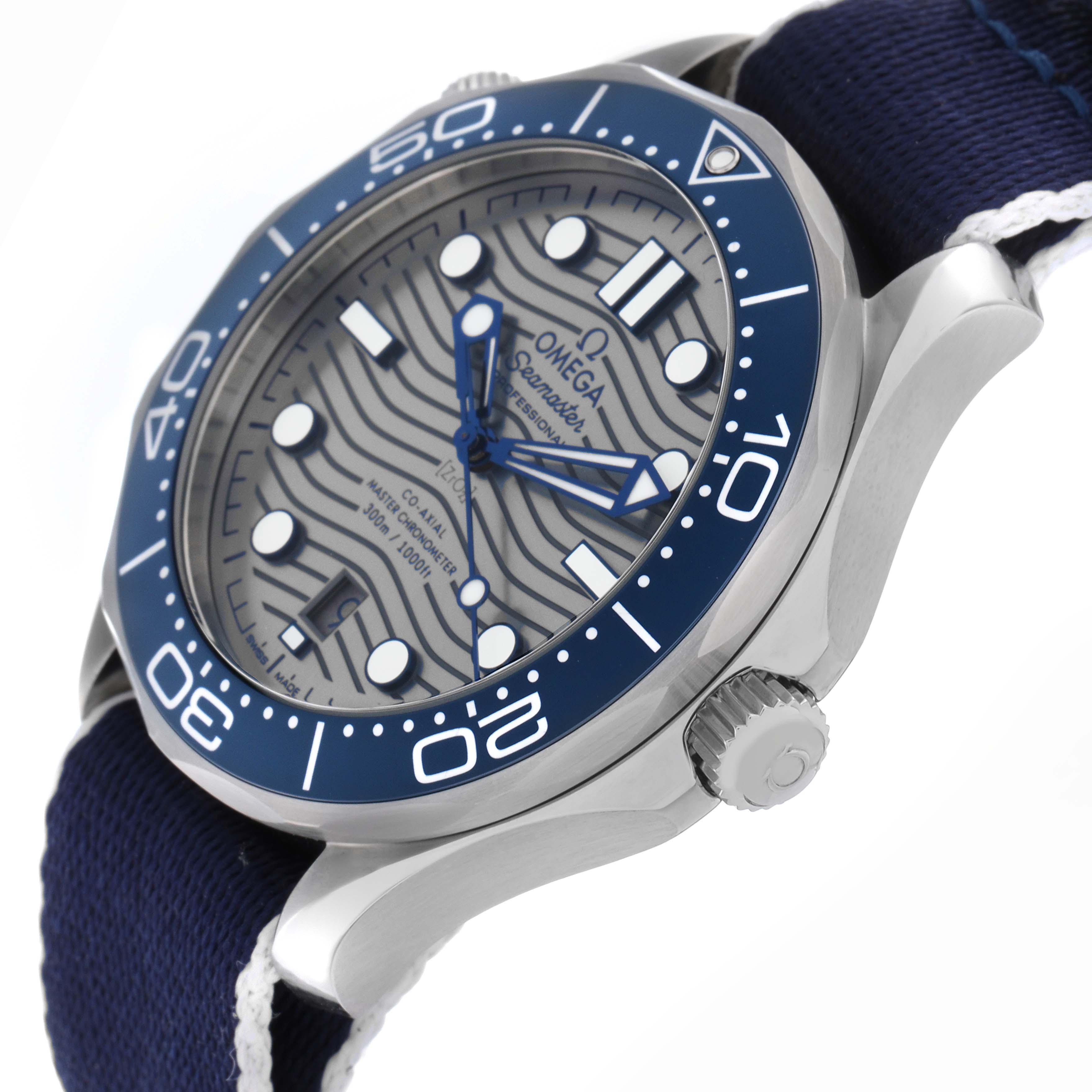 The image shows an angled side view of the Omega Seamaster 210.30.42.20.06.001 Men
s Stainless Steel Grey Dial 210.30.42.20.06.001 Men
s Stainless Steel Grey Dial, highlighting the bezel, crown, and dial with a blue fabric strap.