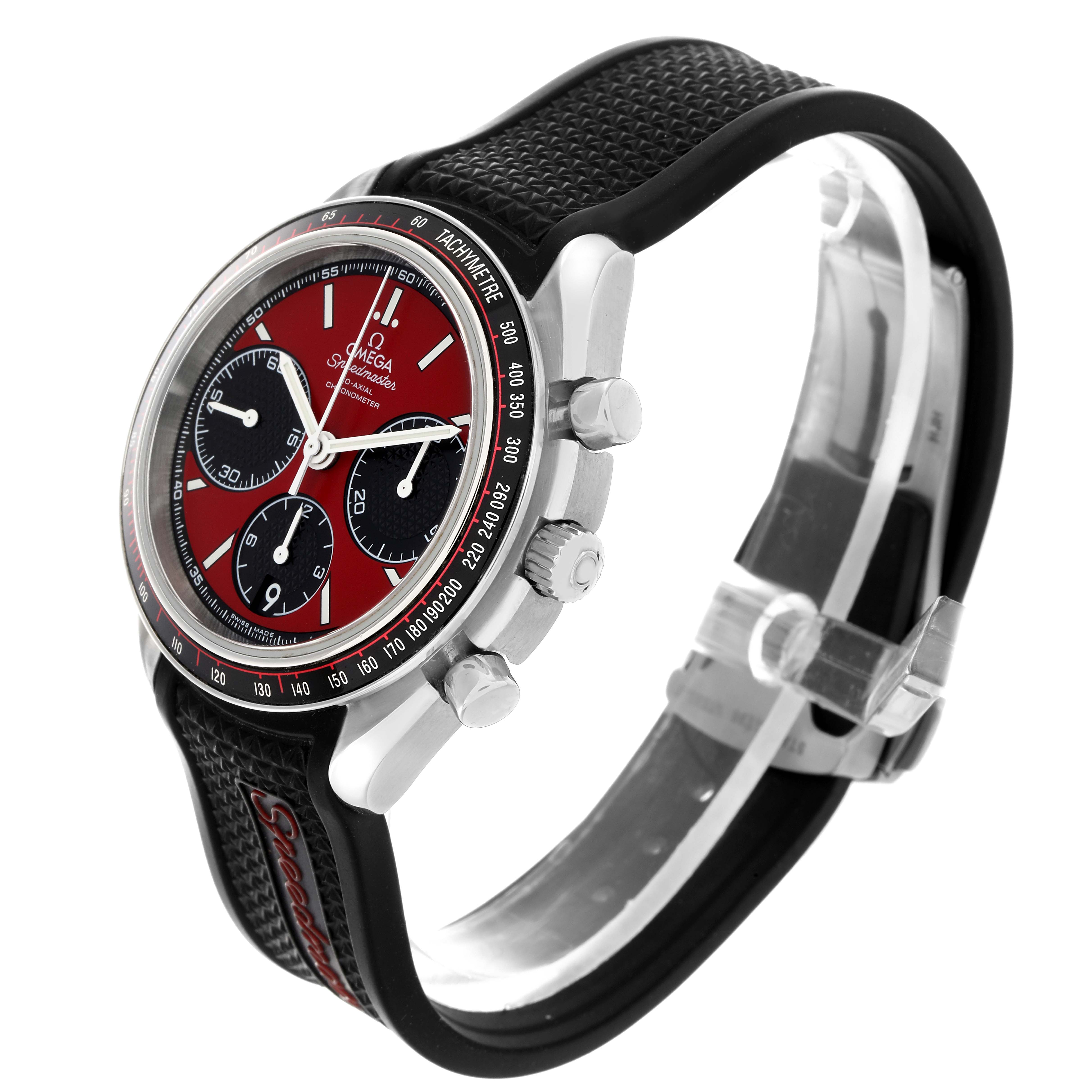 The Omega Speedmaster 326.32.40.50.11.001 Men
s Stainless Steel Red Dial 326.32.40.50.11.001 Men
s Stainless Steel Red Dial watch is shown at a side angle, highlighting the dial, bezel, pushers, and textured strap.