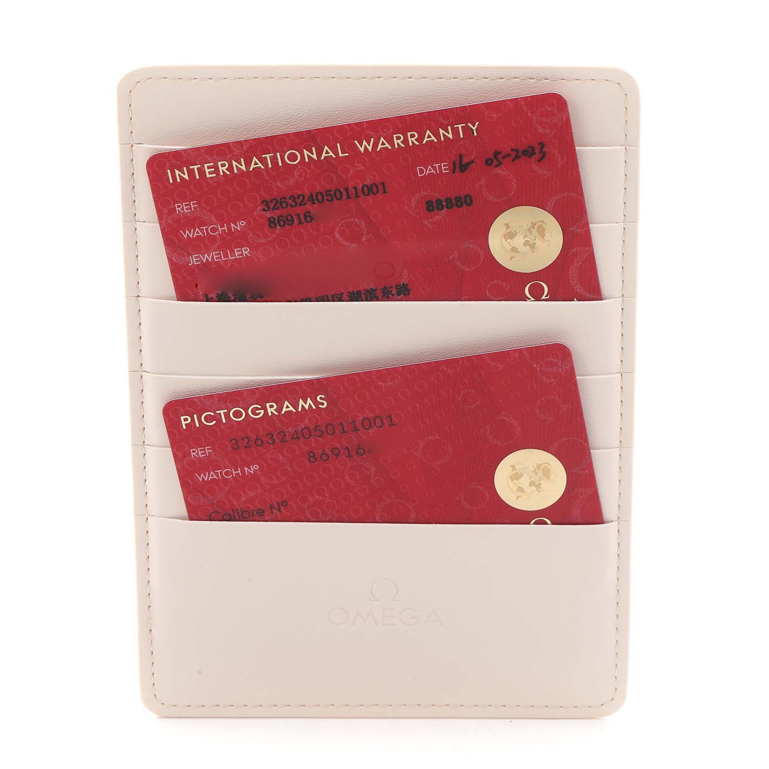 The image shows Omega Speedmaster 326.32.40.50.11.001 Men
s Stainless Steel Red Dial 326.32.40.50.11.001 Men
s Stainless Steel Red Dial
s warranty and pictogram cards in a white cardholder.