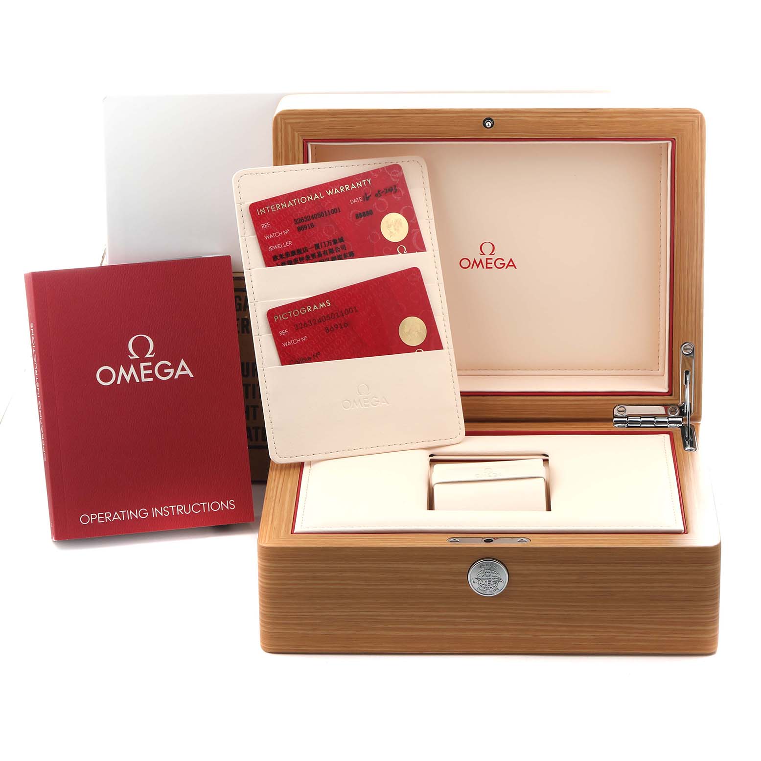The image shows Omega Speedmaster 326.32.40.50.11.001 Men
s Stainless Steel Red Dial 326.32.40.50.11.001 Men
s Stainless Steel Red Dial accessories, including an open wood box, manuals, and warranty cards from a frontal angle.