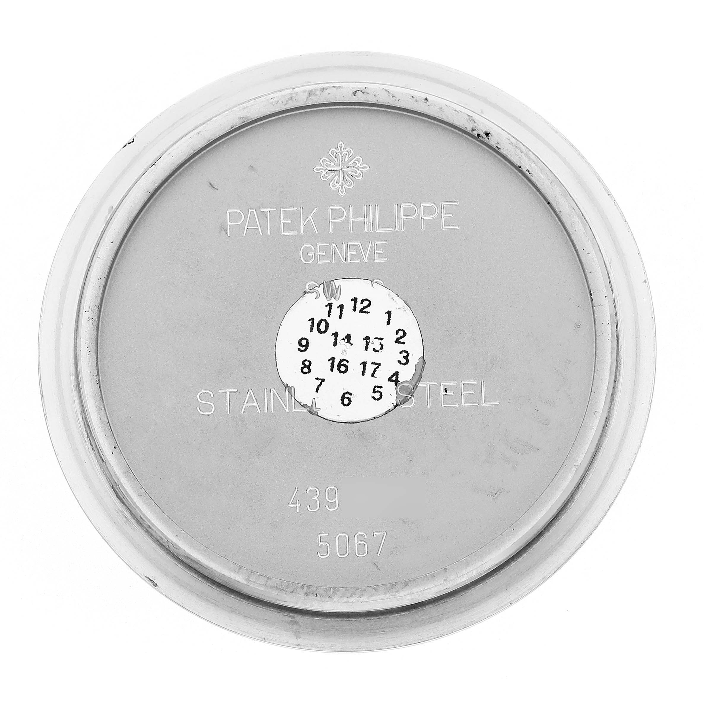 The image shows the inside of a Patek Philippe Aquanaut 5067A/011 Women's Stainless Steel White Dial case back, highlighting engravings and markings.
