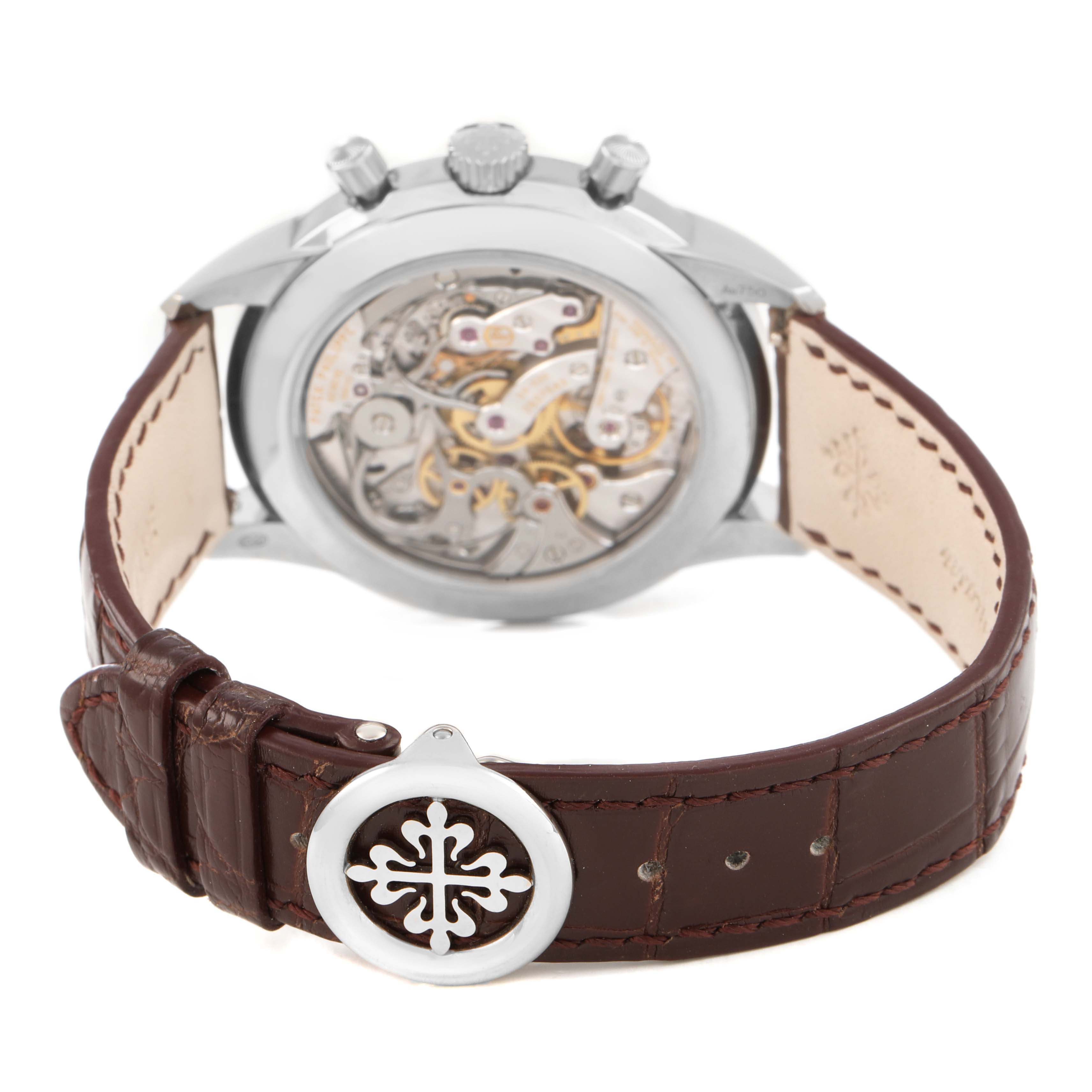The Patek Philippe Complications 5172G-001 Men's White Gold Champagne Dial model is shown from the rear, highlighting its open case back and leather strap with a decorative buckle.