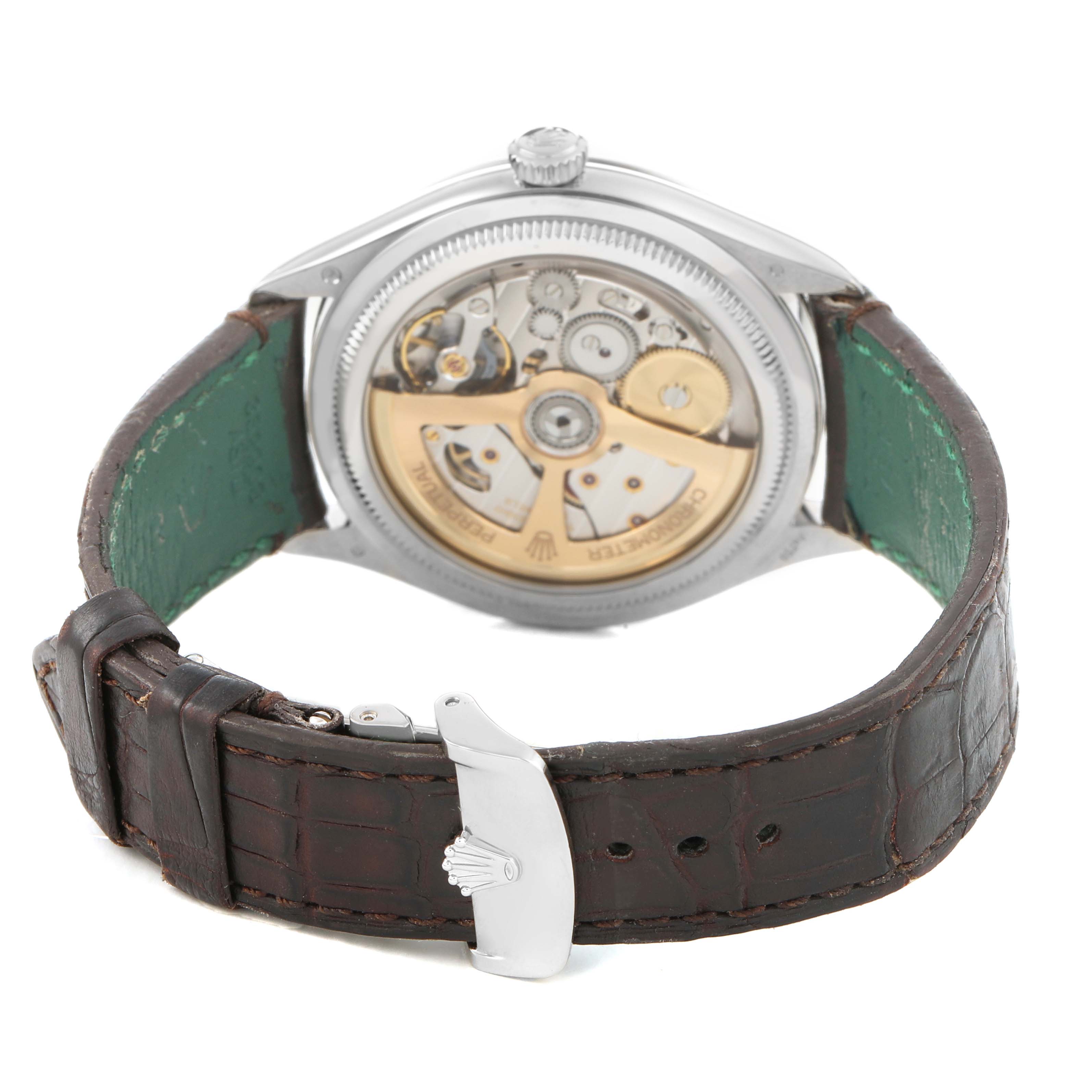 The image shows the back view of a Rolex Cellini 52509 Men's White Gold Silver Dial watch, highlighting its mechanical movement and leather strap with a clasp.