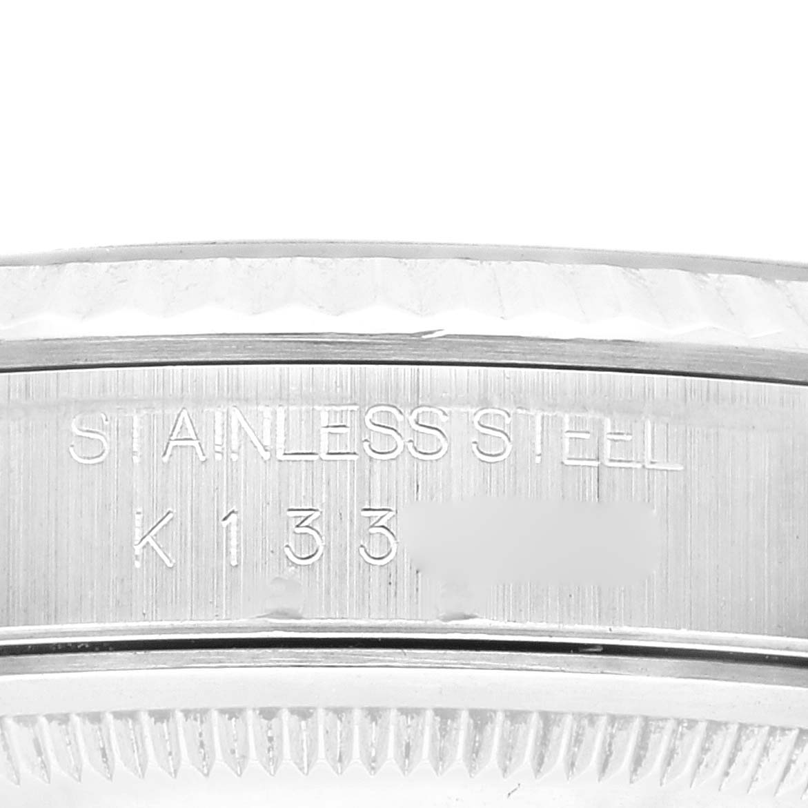 The image shows an angled close-up of the Rolex Datejust 16234 Men's Stainless Steel Blue Dial 16234 Men's Stainless Steel Blue Dial stainless steel case with engraving details visible.