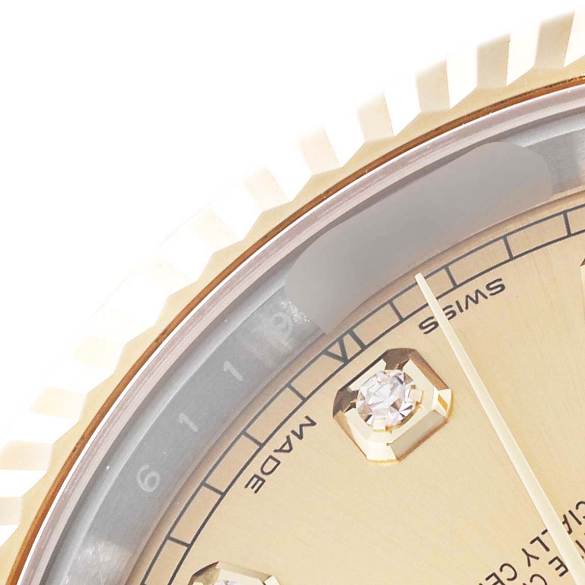 This close-up image of the Rolex Datejust 41 M126333-0012 Men's Steel and Gold (two tone) Champagne Dial M126333-0012 Men's Steel and Gold (two tone) Champagne Dial watch showcases part of the face, diamond markers, and the fluted bezel.