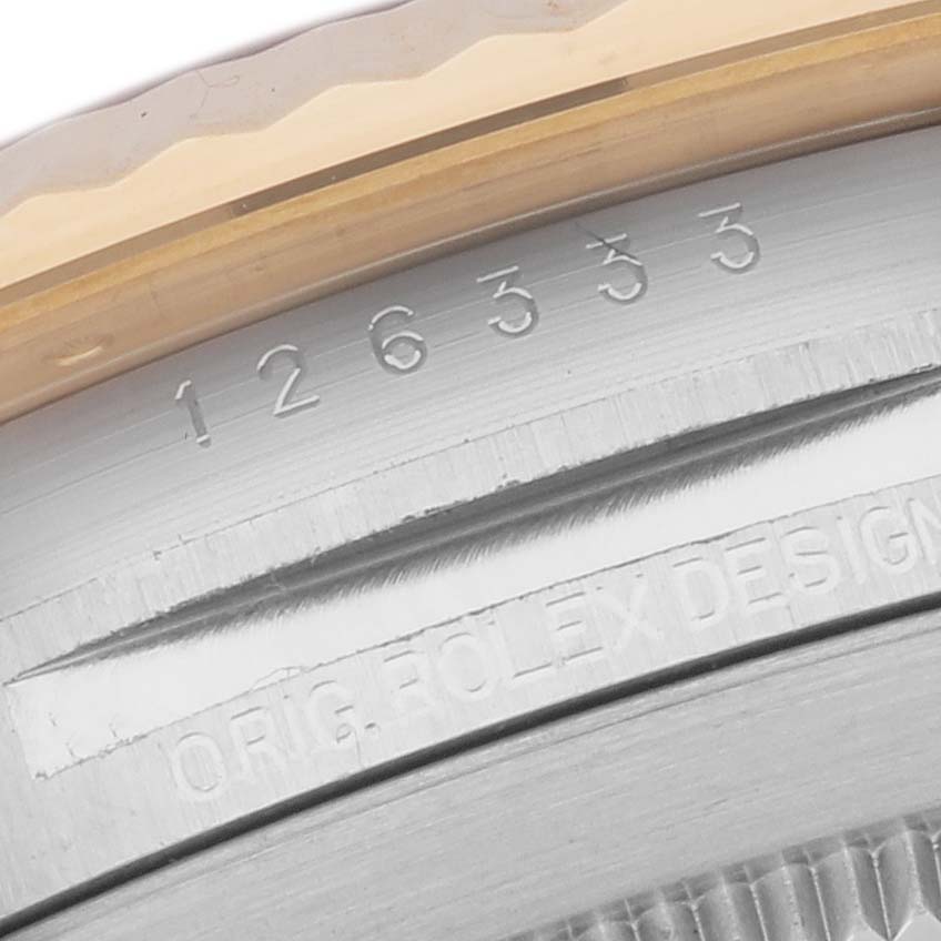 This image shows a close-up of the Rolex Datejust 41 M126333-0012 Men's Steel and Gold (two tone) Champagne Dial M126333-0012 Men's Steel and Gold (two tone) Champagne Dial model's case with the serial and model numbers engraved.