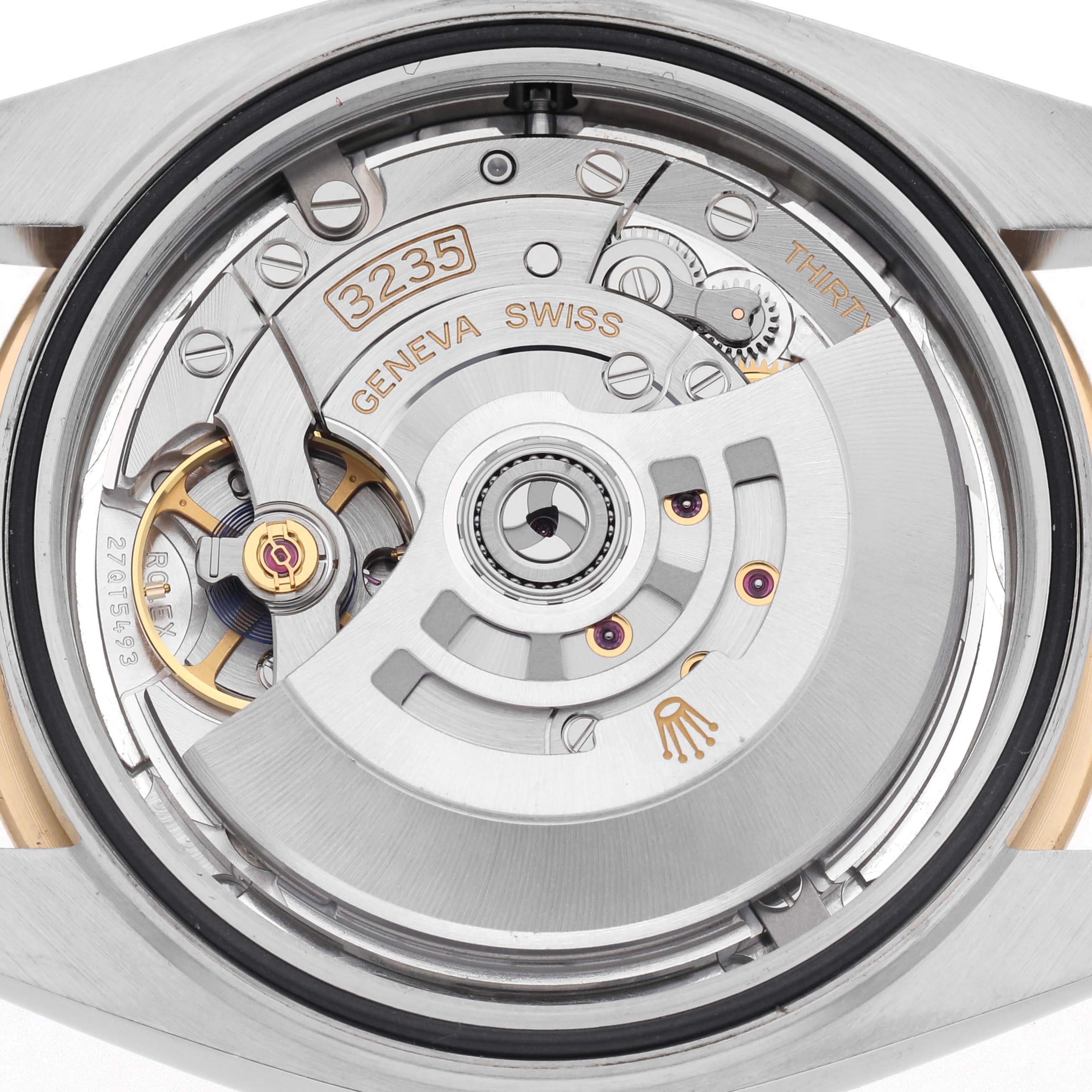 This image shows the intricate movement of the Rolex Datejust 41 126303 Men
s Steel and Gold (two tone) Silver Dial 126303 Men
s Steel and Gold (two tone) Silver Dial from the back angle, highlighting the rotor and internal components.