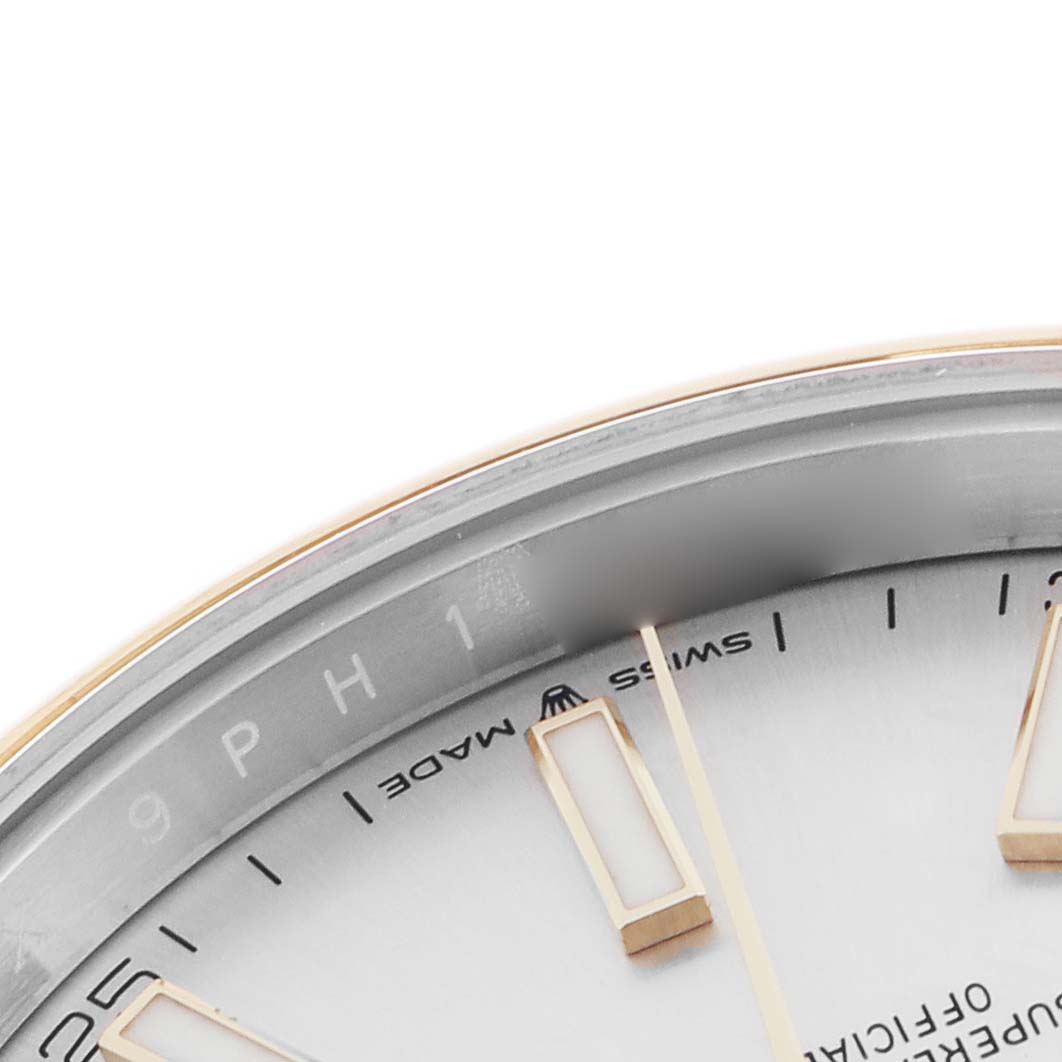 The image shows a close-up of the dial edge and hour markers of a Rolex Datejust 41 126303 Men
s Steel and Gold (two tone) Silver Dial 126303 Men
s Steel and Gold (two tone) Silver Dial, highlighting its bezel and part of the dial.