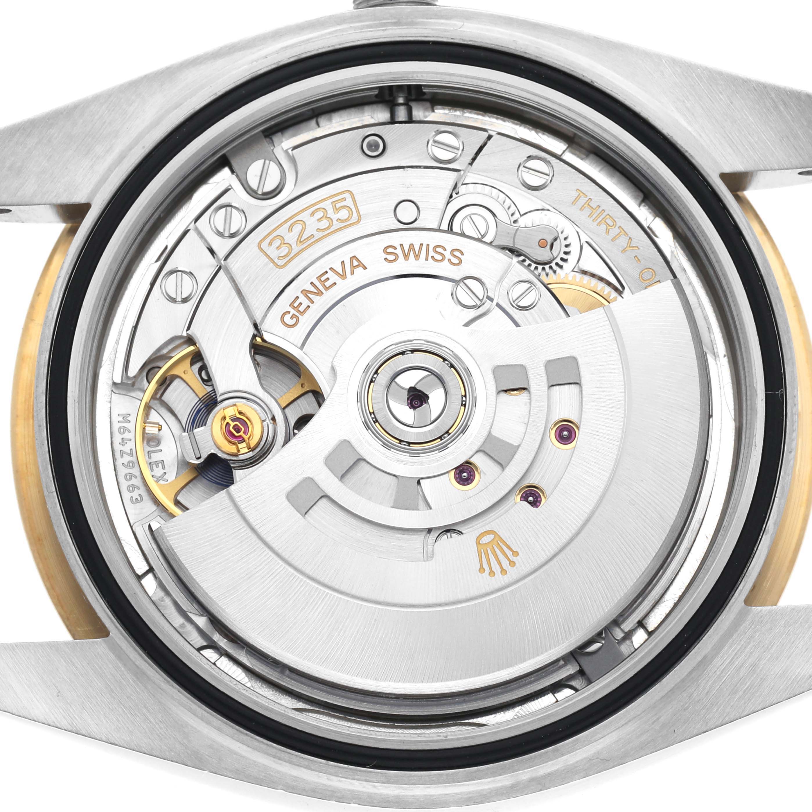 The Rolex Datejust 41 126333 Men
s Steel and Gold (two tone) Silver Dial 126333 Men
s Steel and Gold (two tone) Silver Dial watch is shown from the back, revealing its intricate movement and parts like the rotor and gears.