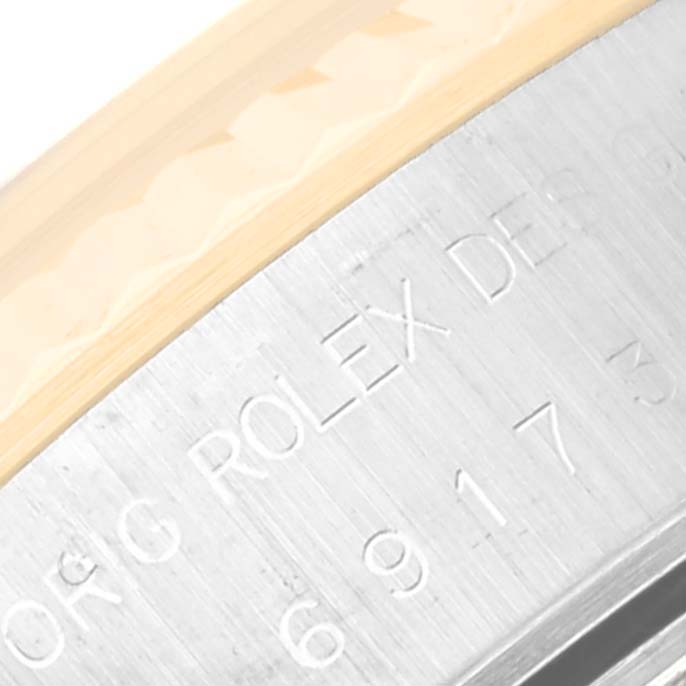 This close-up image shows the side of the case of a Rolex Datejust 69173 Women's Steel and Gold (two tone) White Dial 69173 Women's Steel and Gold (two tone) White Dial watch, focusing on the engraved text.