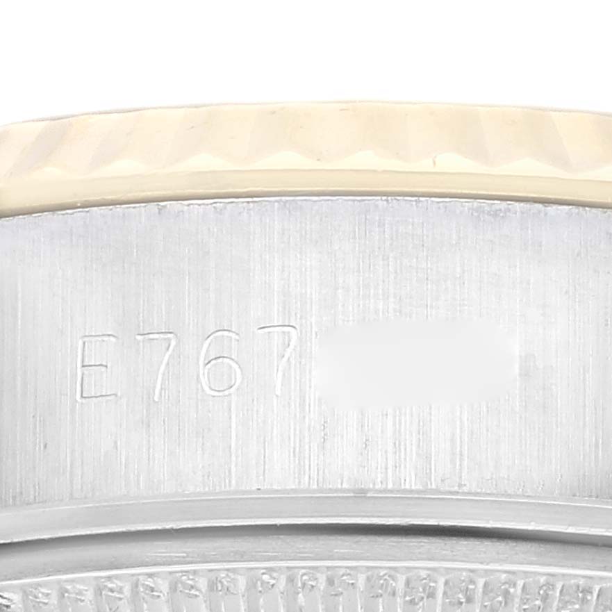 This close-up shows part of the case and bezel with visible engravings of a Rolex Datejust 69173 Women's Steel and Gold (two tone) Champagne Dial 69173 Women's Steel and Gold (two tone) Champagne Dial model.