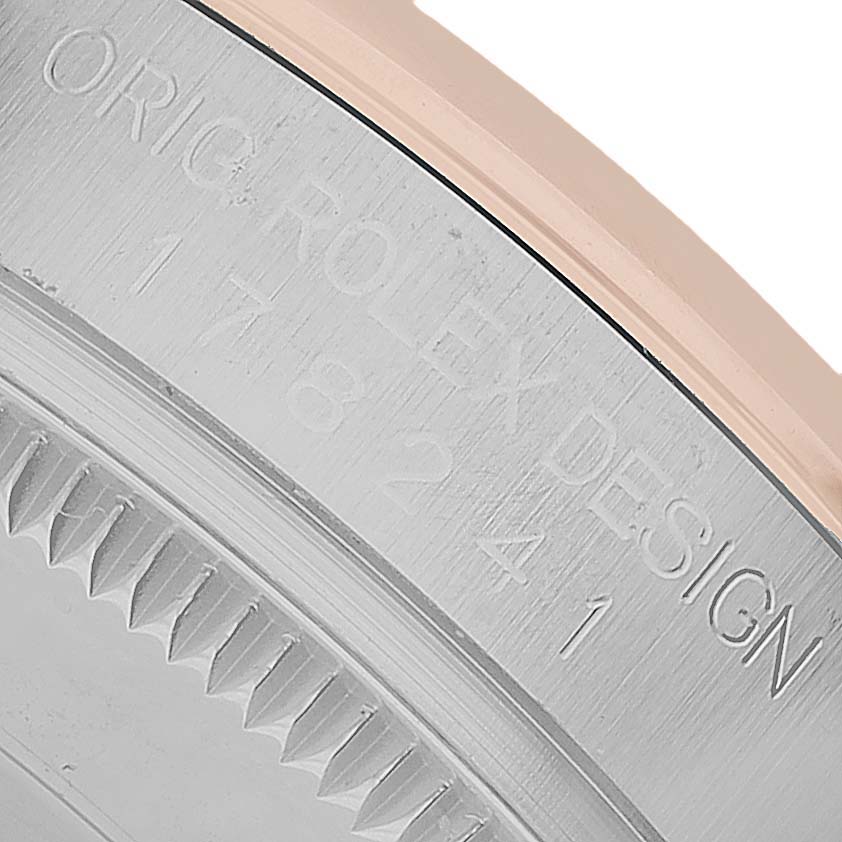 The image shows an angled close-up of the edge of a Rolex Datejust 178241 Women's Steel and Gold (two tone) White Dial’s case, displaying its model details.
