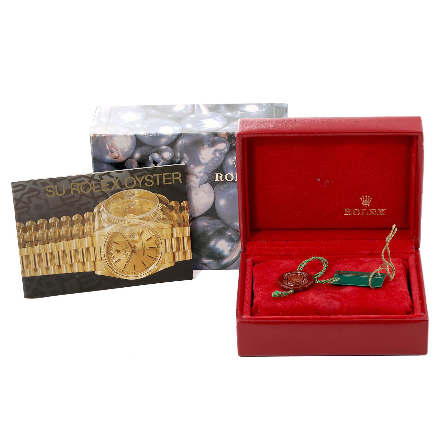 The image shows various parts and accessories of a Rolex Datejust 69173 Women's Steel and Gold (two tone) White Dial 69173 Women's Steel and Gold (two tone) White Dial, including the box, tags, and the watch's booklet from an angled view.