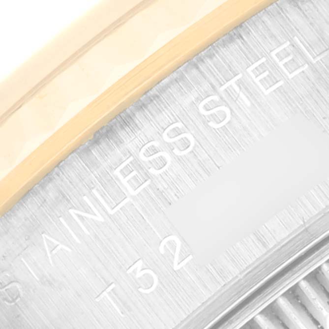This close-up image shows the "Rolex Datejust 69173 Women's Steel and Gold (two tone) White Dial 69173 Women's Steel and Gold (two tone) White Dial" model's stainless steel case part with engraved text.