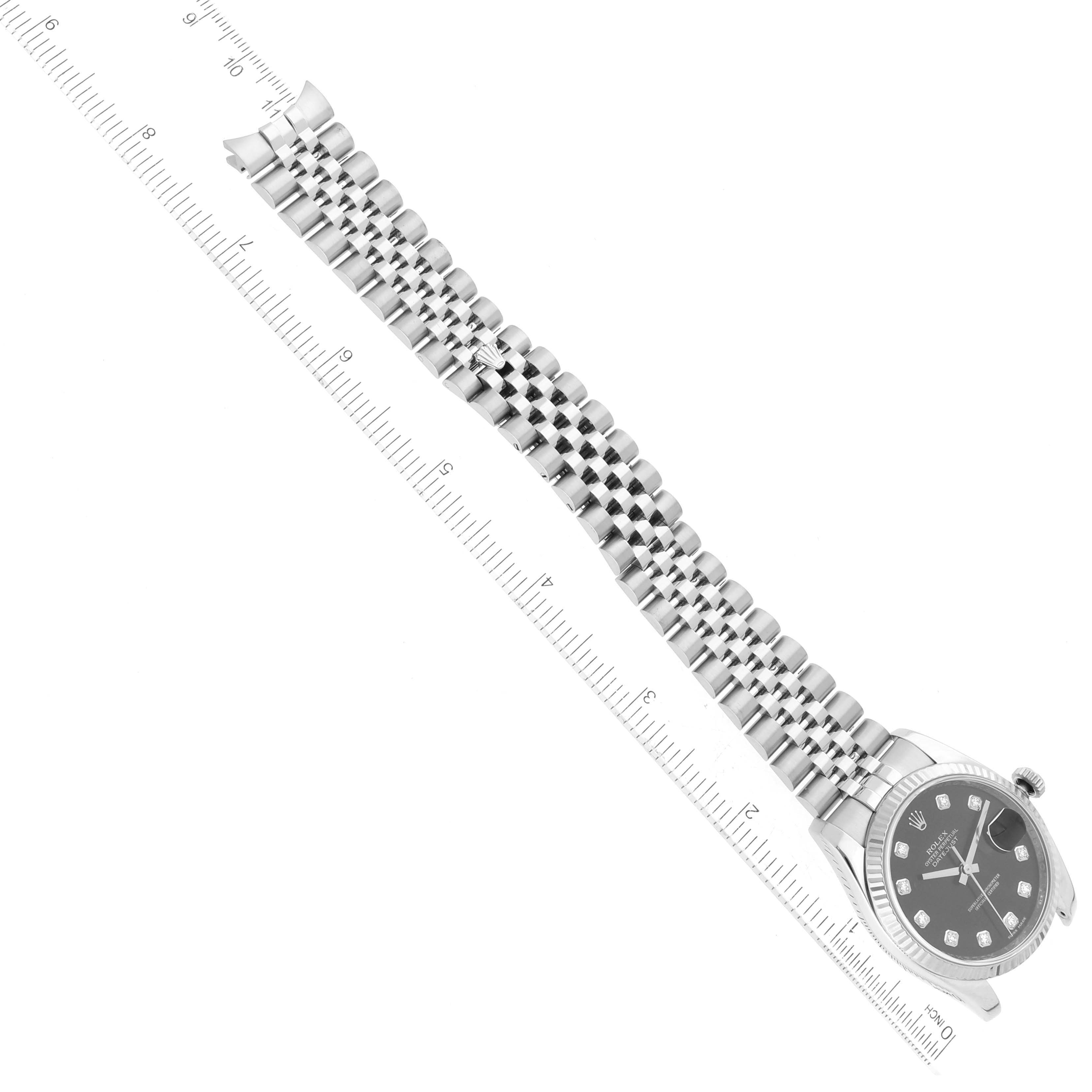 The image shows the face and bracelet of a Rolex Datejust 116234 Men's Stainless Steel Black Dial 116234 Men's Stainless Steel Black Dial watch, positioned against a ruler for scale.
