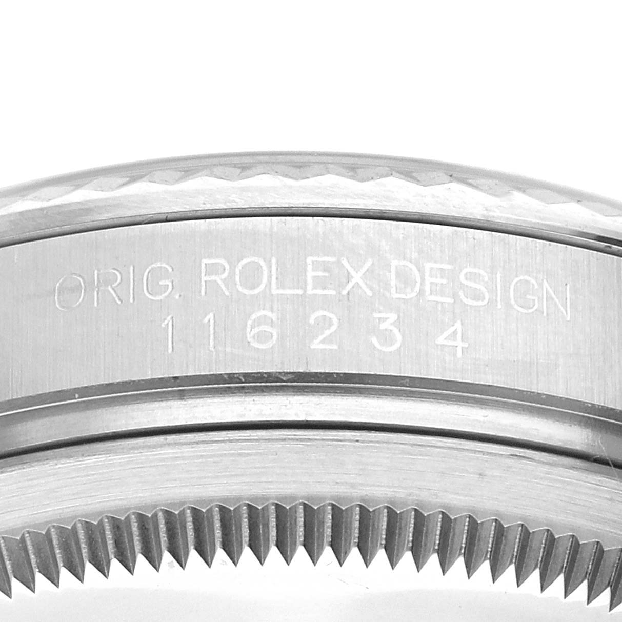 This image shows a close-up view of the engraved bezel and case of a Rolex Datejust 116234 Men's Stainless Steel Silver Dial 116234 Men's Stainless Steel Silver Dial watch.