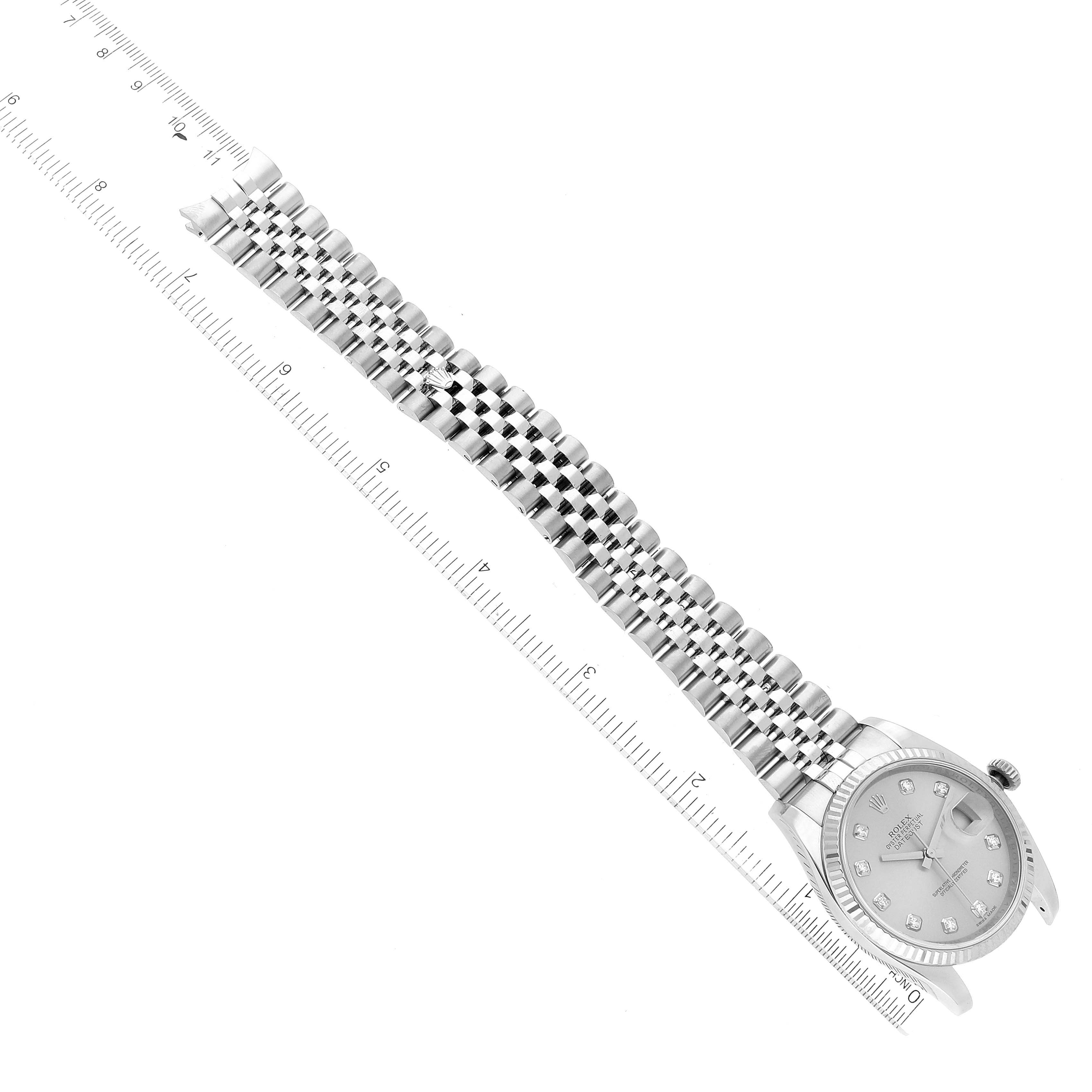 The image shows a Rolex Datejust 116234 Men's Stainless Steel Silver Dial 116234 Men's Stainless Steel Silver Dial watch laid flat with its full-length metal bracelet and a ruler next to it for scale.