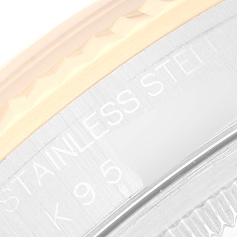 The image shows a close-up of the fluted bezel and part of the case engraving of a Rolex Datejust 16233 Men's Steel and Gold (two tone) Champagne Dial 16233 Men's Steel and Gold (two tone) Champagne Dial watch.