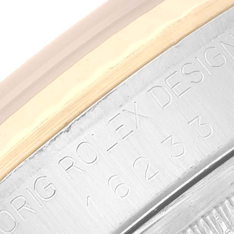 This close-up image shows the engraved edge of the bezel on a Rolex Datejust 16233 Men's Steel and Gold (two tone) Black Dial 16233 Men's Steel and Gold (two tone) Black Dial watch.