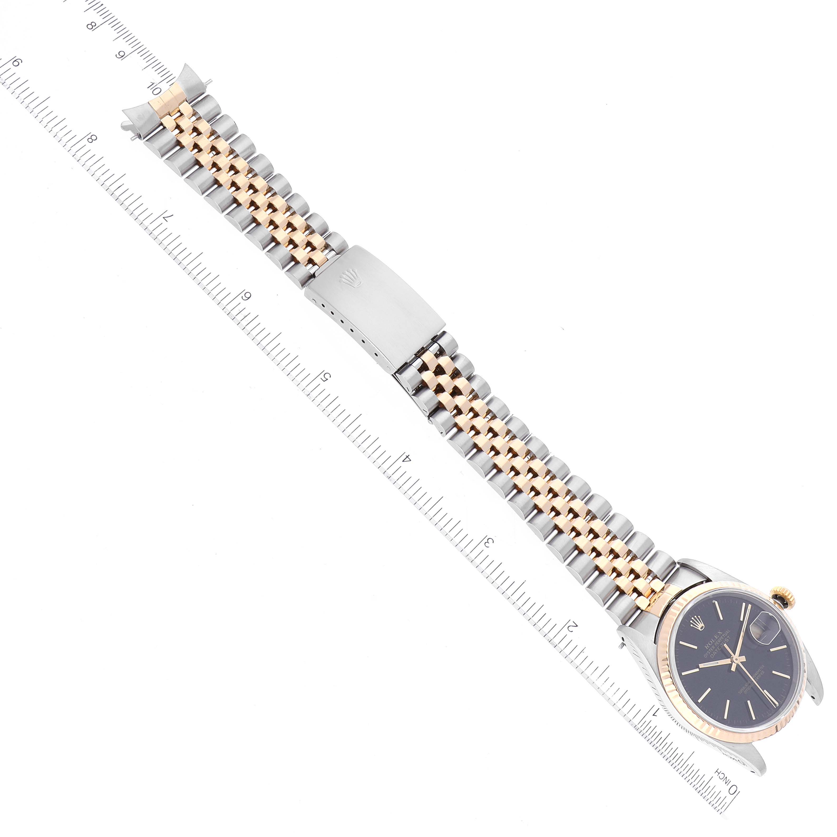 The image shows a flat-laid Rolex Datejust 16233 Men's Steel and Gold (two tone) Black Dial 16233 Men's Steel and Gold (two tone) Black Dial watch, highlighting its face, bezel, and detailed two-tone bracelet with a clasp.