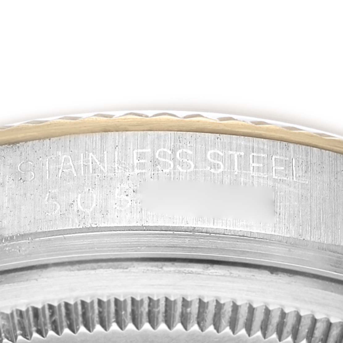 The image shows a close-up of the side edge, bezel, and engravings of a Vintage Collection Rolex watch.