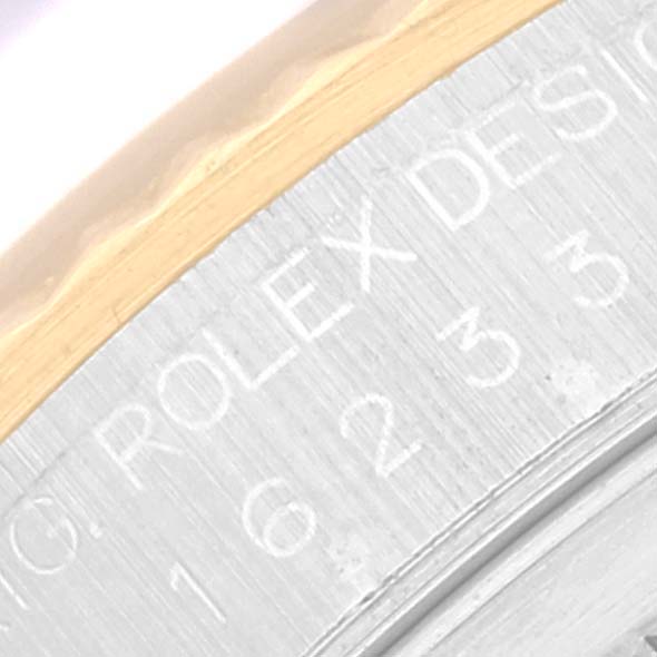 The image shows an angled close-up of the engraving on the bezel and side of a Rolex Datejust 16233 Men's Steel and Gold (two tone) White Dial 16233 Men's Steel and Gold (two tone) White Dial watch.