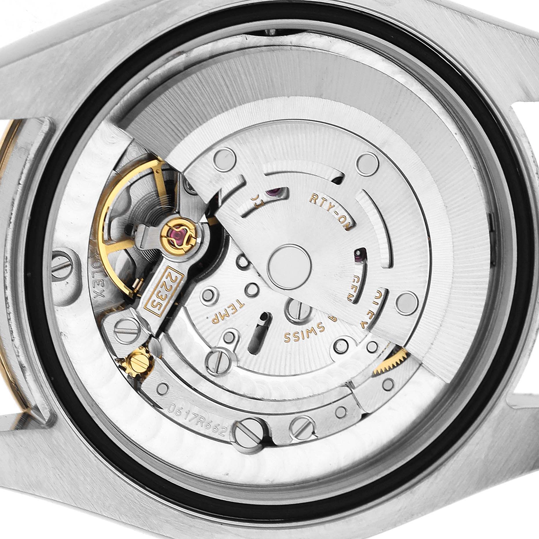 The image shows a close-up of the movement inside a Rolex Datejust 69173 Women's Steel and Gold (two tone) White Dial watch, highlighting its intricate mechanical components.