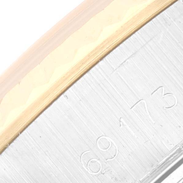 This image shows a close-up of the side of the bezel and the case of a Rolex Datejust 69173 Women's Steel and Gold (two tone) Silver Dial 69173 Women's Steel and Gold (two tone) Silver Dial watch, focusing on part of its serial number.