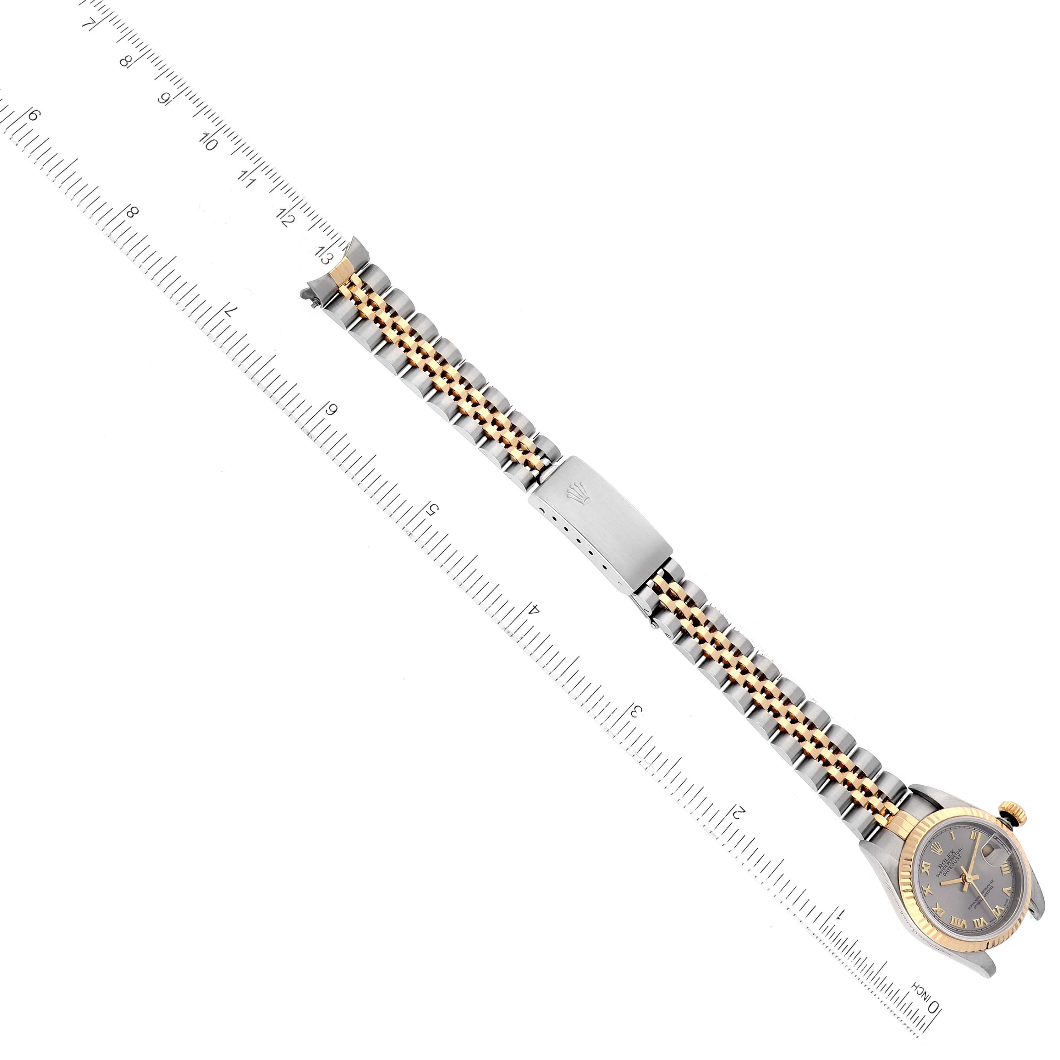 The image shows the entire Rolex Datejust 79173 Women's Steel and Gold (two tone) Silver Dial 79173 Women's Steel and Gold (two tone) Silver Dial watch laid flat, with the face and bracelet visible, and a ruler for scale.