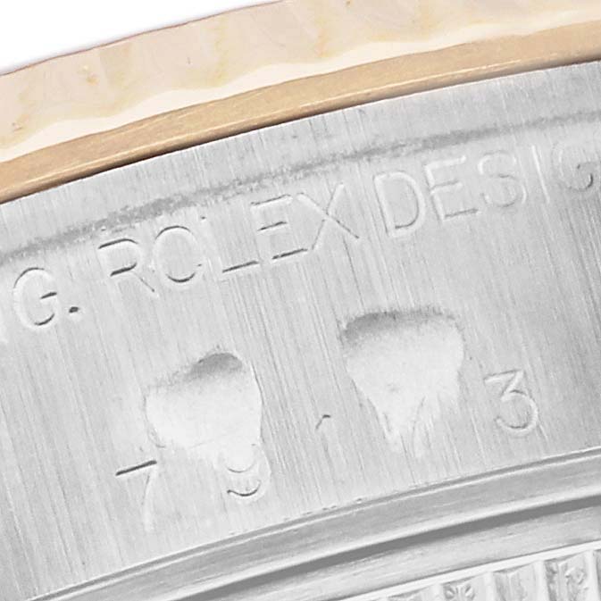 The image shows a close-up of the engraved case edge of a Rolex Datejust 79173 Women's Steel and Gold (two tone) Silver Dial 79173 Women's Steel and Gold (two tone) Silver Dial watch.