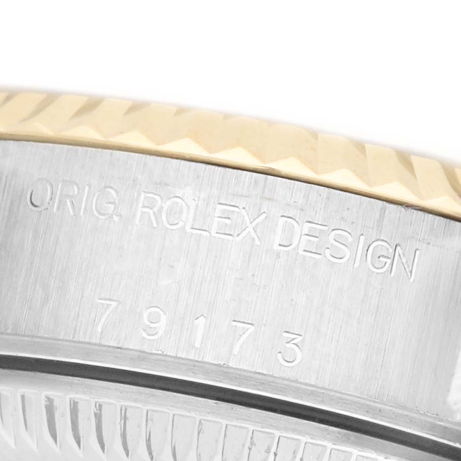 The image shows a close-up of the Rolex Datejust 79173 Women's Steel and Gold (two tone) Silver Dial model bezel and case, highlighting the engraved "Orig. Rolex Design" text.