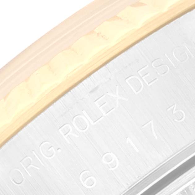 The close-up image shows the engraved case side of a Rolex Datejust 69173 Women's Steel and Gold (two tone) Grey Dial 69173 Women's Steel and Gold (two tone) Grey Dial model watch.