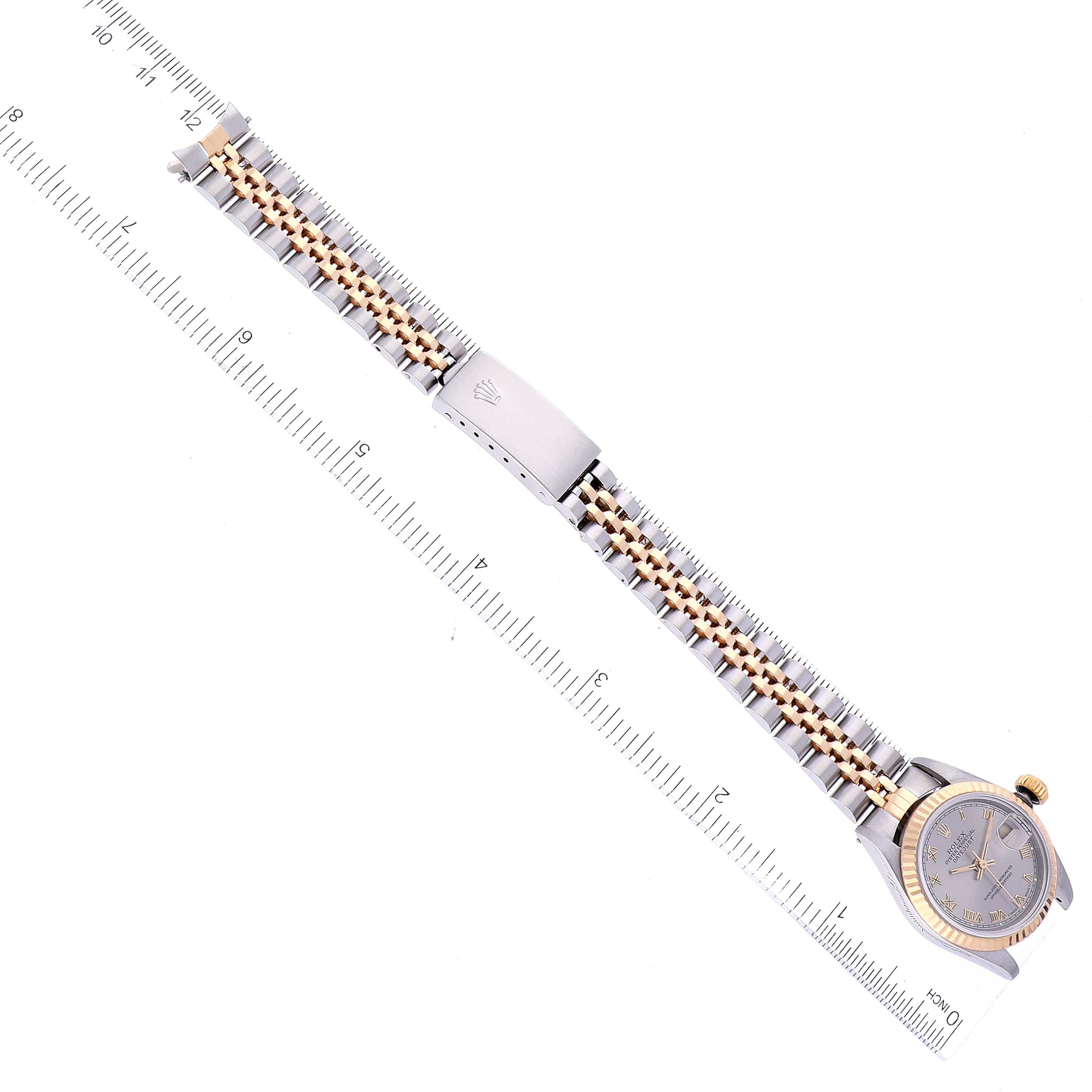 The Rolex Datejust 69173 Women's Steel and Gold (two tone) Grey Dial 69173 Women's Steel and Gold (two tone) Grey Dial watch is shown from a top-down angle along with its entire band and part of a ruler.