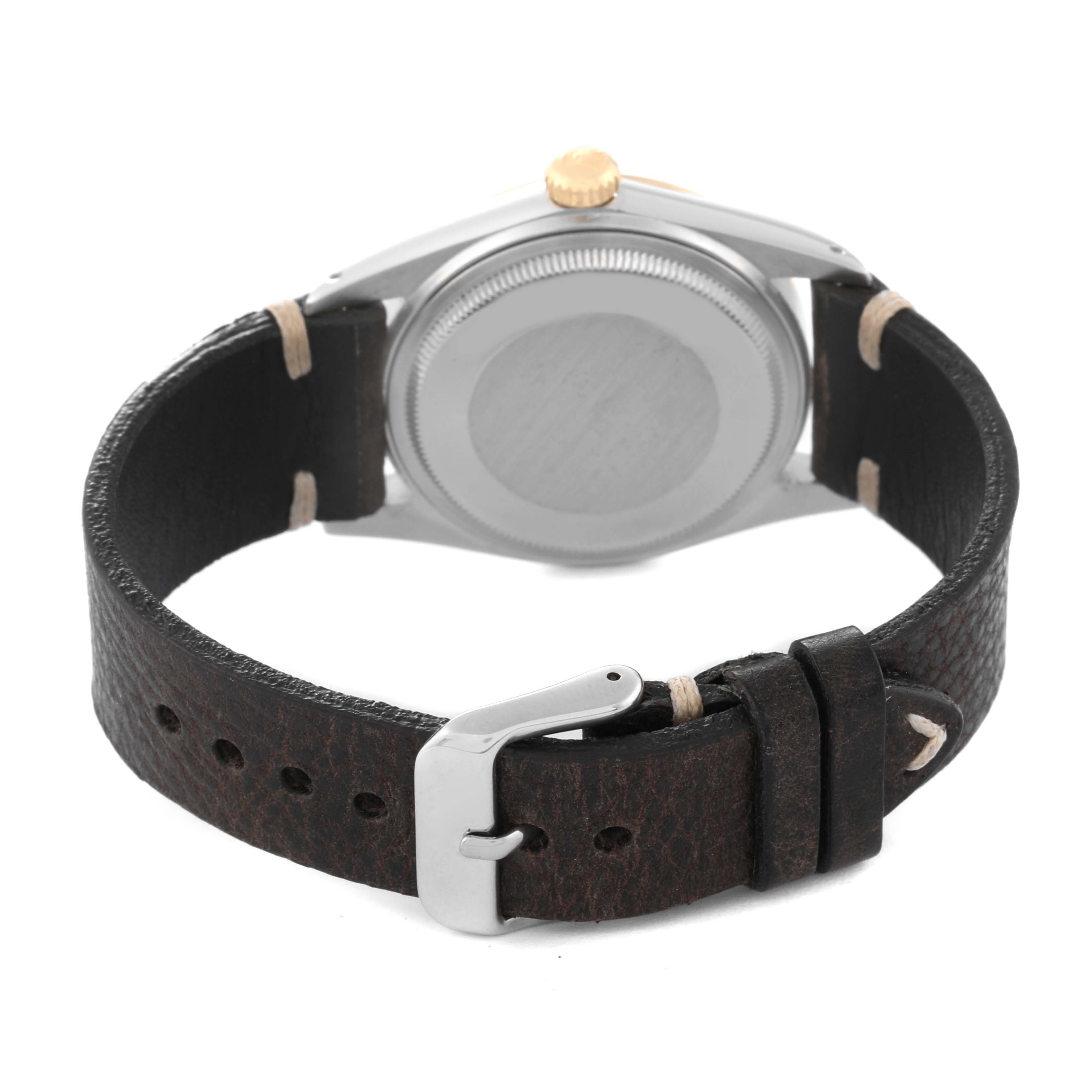 The image shows the back view of a Vintage Collection model by Rolex, highlighting the case back and leather strap with buckle.