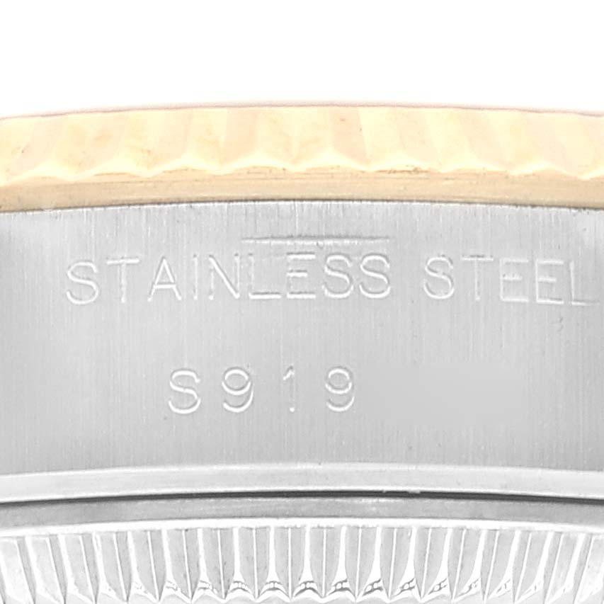 This image shows a close-up of the stainless steel edge and fluted bezel of a Rolex Datejust 69173 Women's Steel and Gold (two tone) White Dial 69173 Women's Steel and Gold (two tone) White Dial watch.