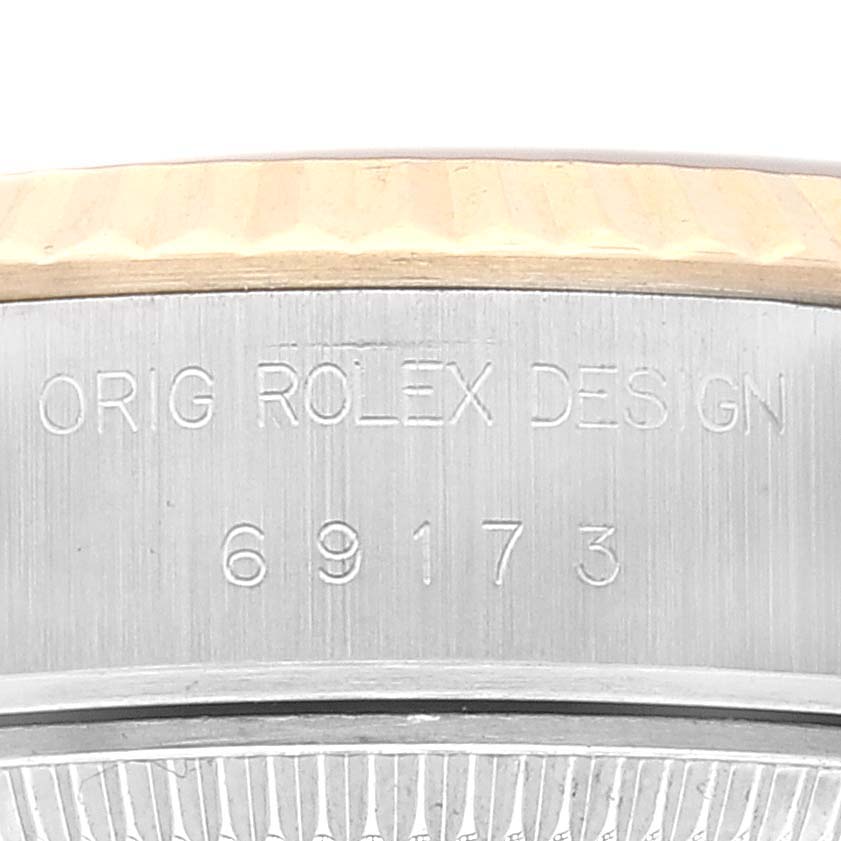 The image shows a close-up of the case back edge of a Rolex Datejust 69173 Women's Steel and Gold (two tone) White Dial 69173 Women's Steel and Gold (two tone) White Dial model, highlighting the engraved text and model number "69173."
