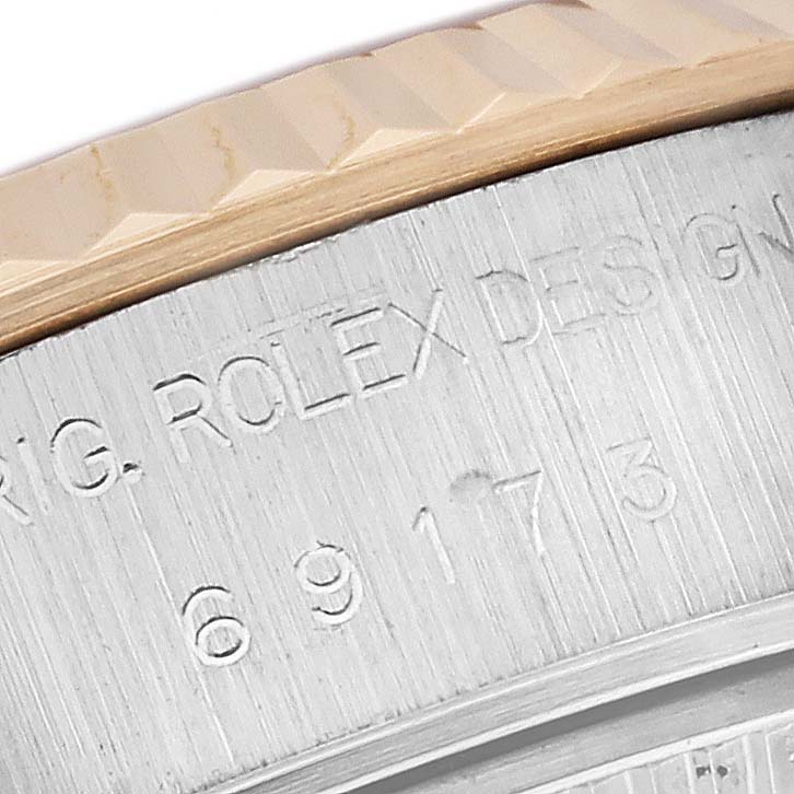 This close-up image shows the model number and part of the bezel of a Rolex Datejust 69173 Women's Steel and Gold (two tone) White Dial 69173 Women's Steel and Gold (two tone) White Dial watch.