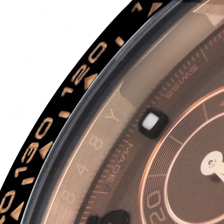 The image shows a close-up of the bezel and partial dial of the Rolex Daytona 116515LN Men's Rose Gold Brown Dial watch.