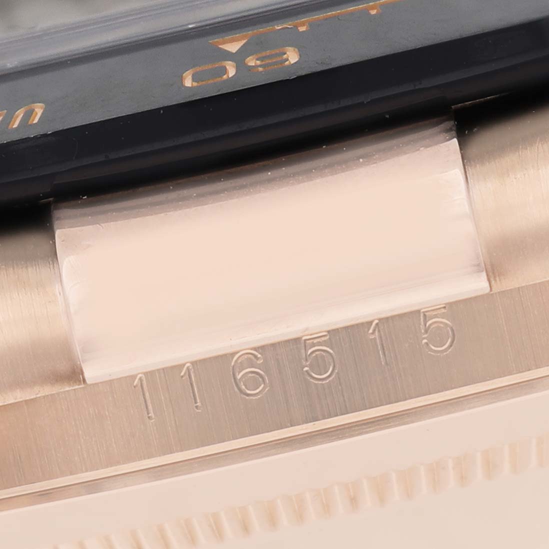 The image shows a close-up of the side of a Rolex Daytona 116515LN Men's Rose Gold Brown Dial, highlighting the bezel and engraved model number.
