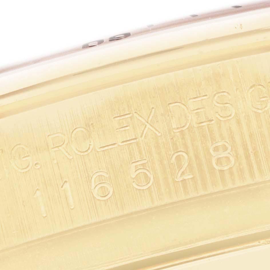 The image shows a close-up of the engraved edge of the Rolex Daytona 116528 Men
s Yellow Gold Black Dial 116528 Men
s Yellow Gold Black Dial, displaying the serial and model numbers.