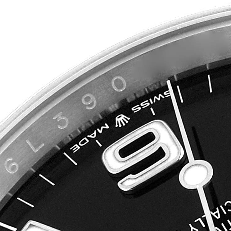 This close-up of the Rolex Explorer 124270 Men's Stainless Steel Black Dial 124270 Men's Stainless Steel Black Dial watch shows the edge of the dial, the '9' hour marker, and part of the hour and minute hands.