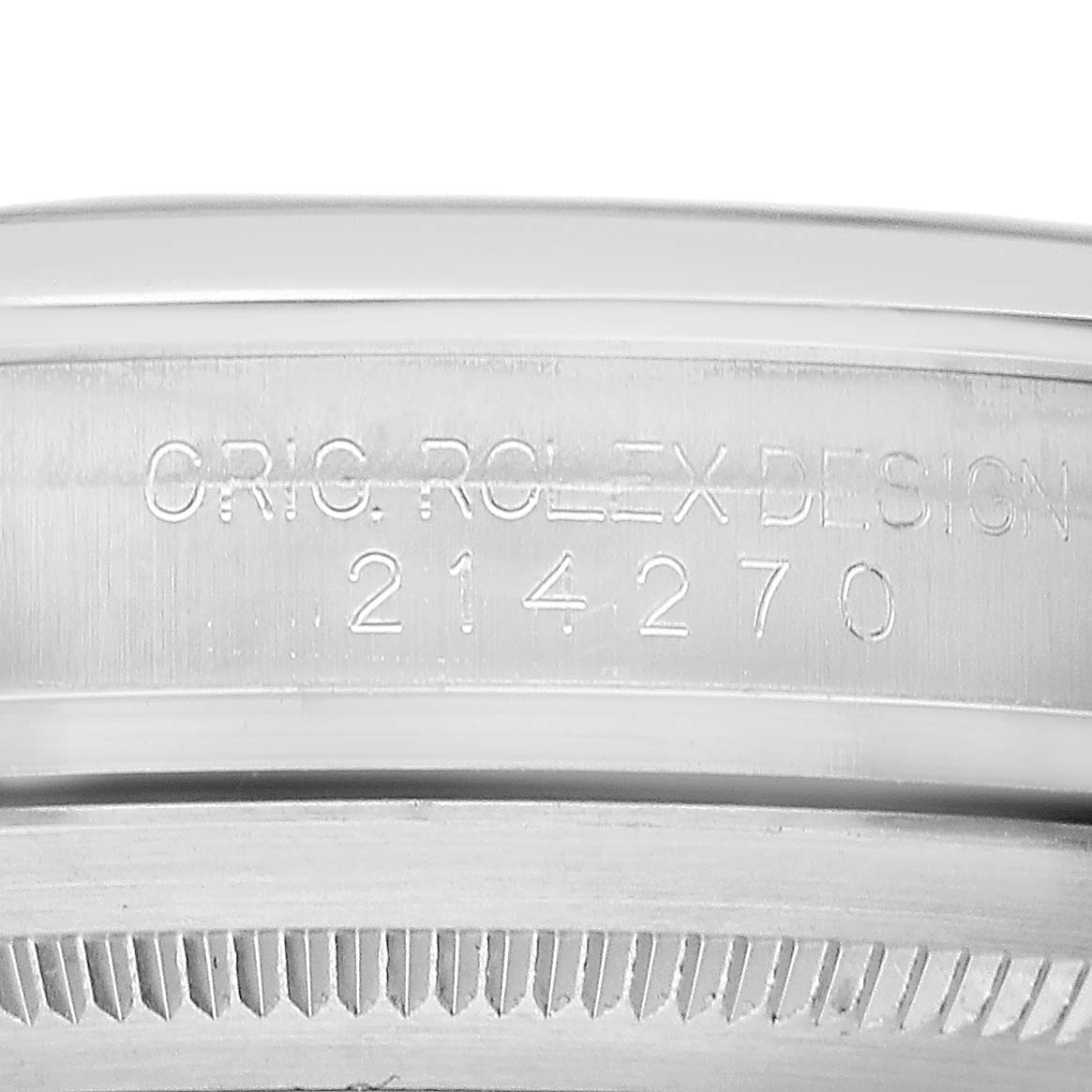 The image shows the case side of a Rolex Explorer 214270 Men's Stainless Steel Black Dial, featuring engraved text and the design number 214270.