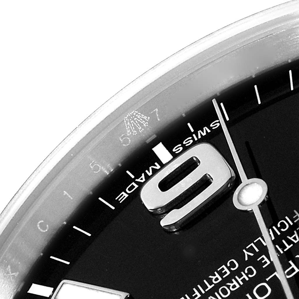 This image shows a close-up angle of the dial of a Rolex Explorer 214270 Men
s Stainless Steel Black Dial 214270 Men
s Stainless Steel Black Dial watch, highlighting the Swiss Made marking and part of the numeral 6.