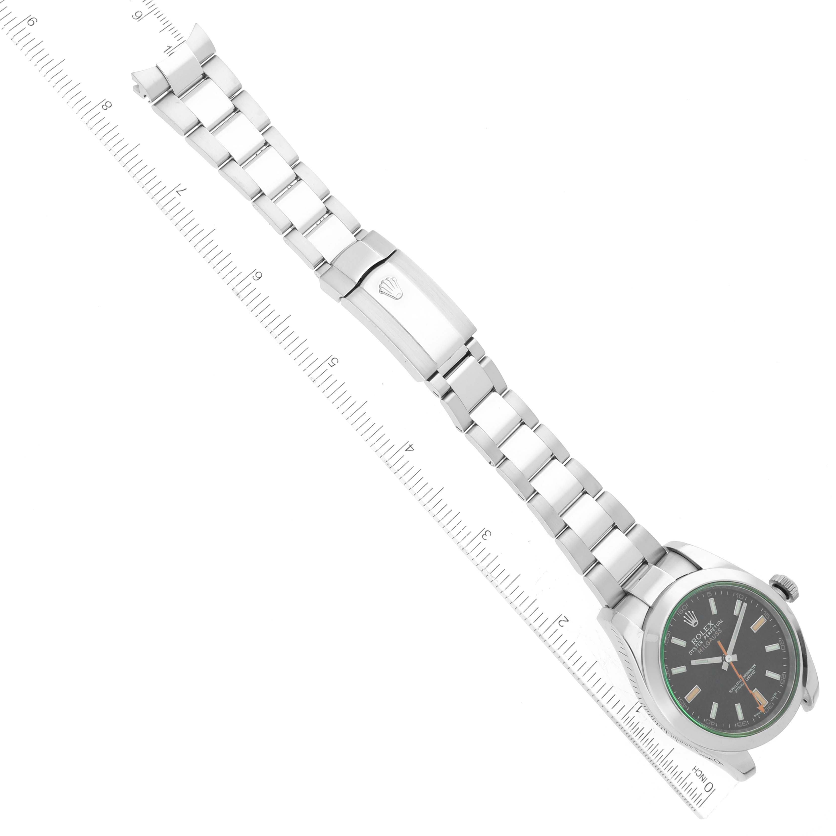 The image shows a Milgauss model Rolex watch from an overhead angle, including the face, bracelet, and clasp.