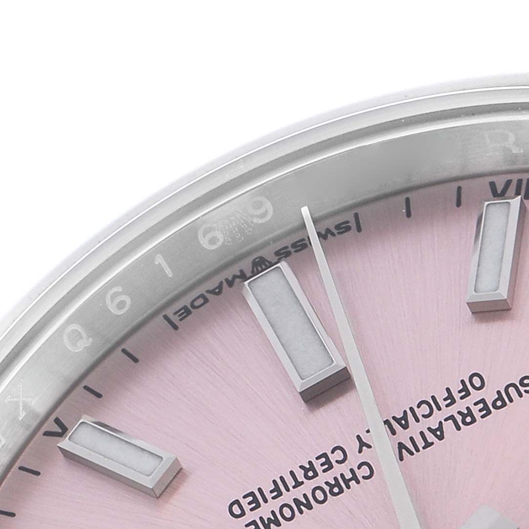 The image shows a close-up of the Rolex Oyster Perpetual 124200 Men
s Stainless Steel Pink Dial 124200 Men
s Stainless Steel Pink Dial watch, featuring part of the dial, index markers, and bezel.