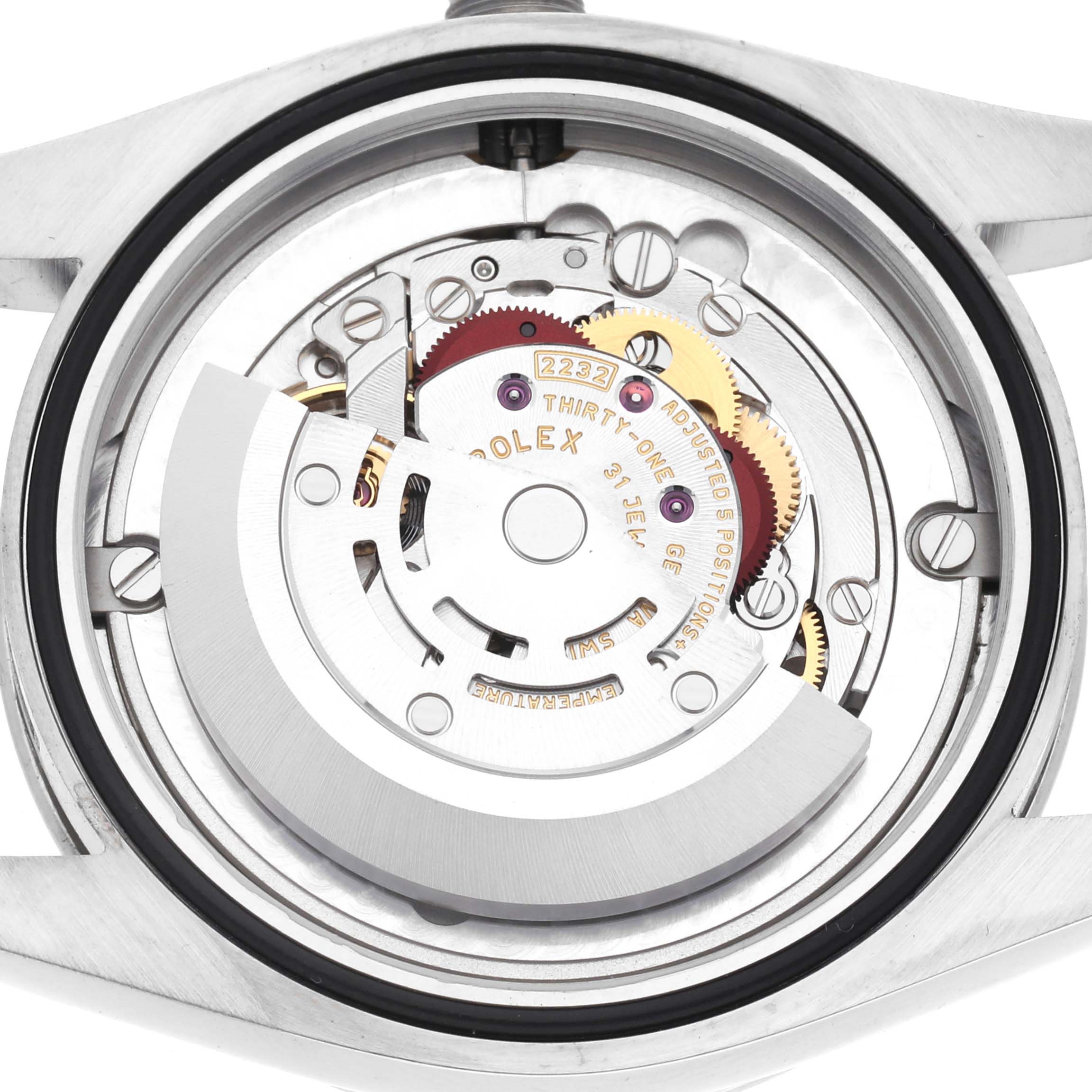 The image shows a close-up view of the movement inside a Rolex Oyster Perpetual 124200 Men
s Stainless Steel Pink Dial 124200 Men
s Stainless Steel Pink Dial watch, highlighting gears and mechanisms.